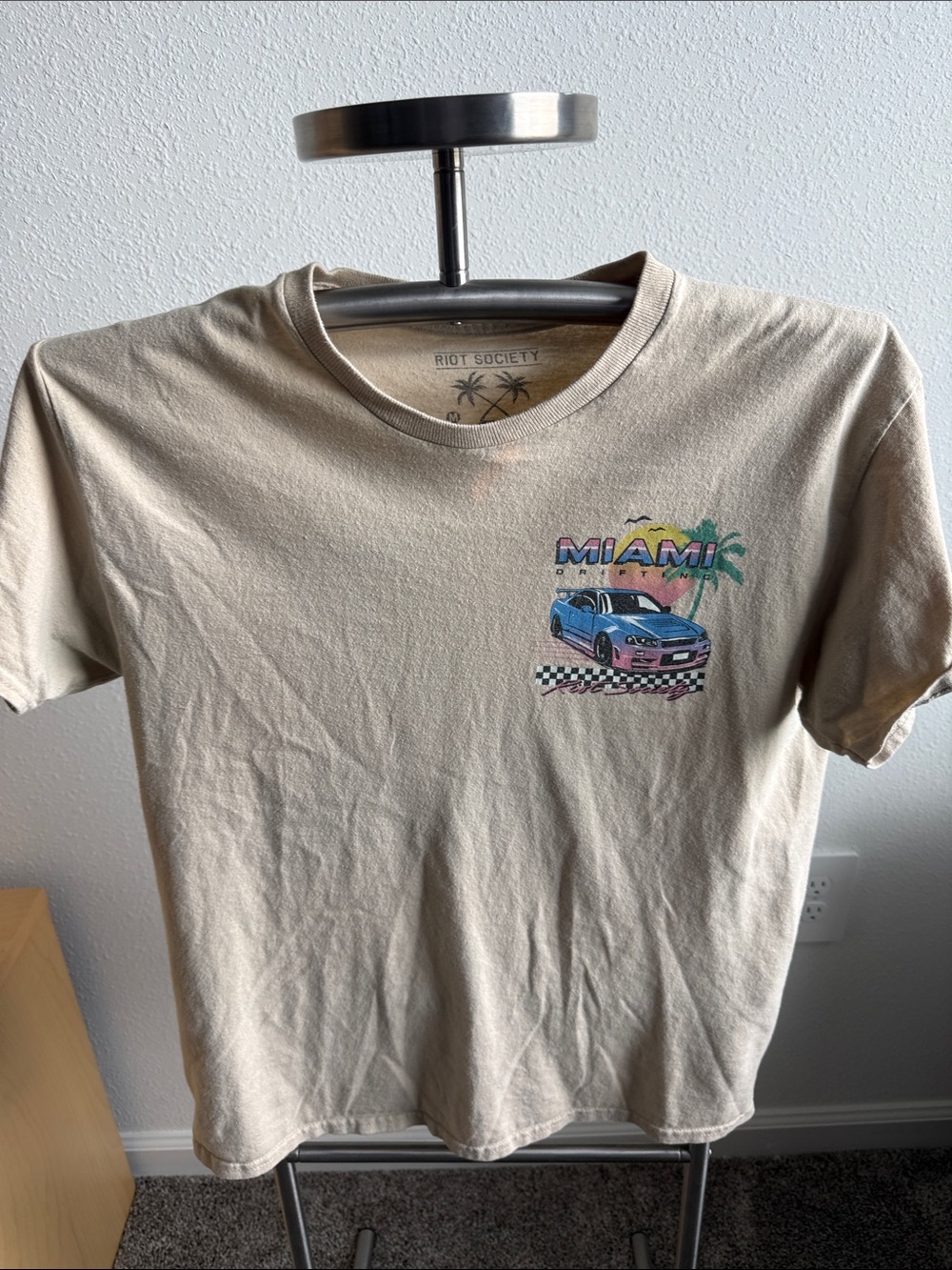 riot society beige tee with blue car and Miami graphic